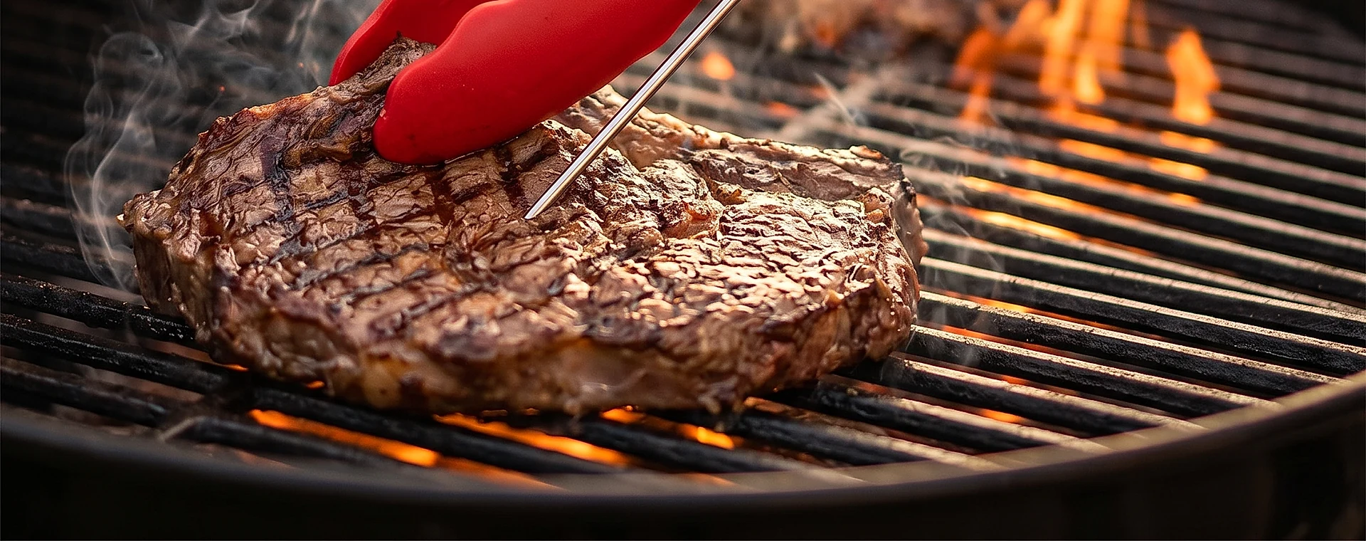 Meat thermometer probe positioned in the centre of grilled steak